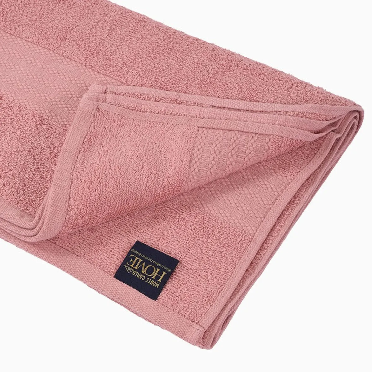 Close-up of pink towel texture, border and stitched brand label