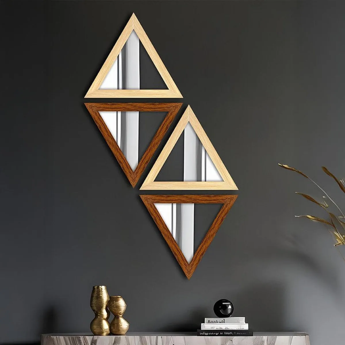 Four triangular beige and brown wall mirrors displayed on a dark wall