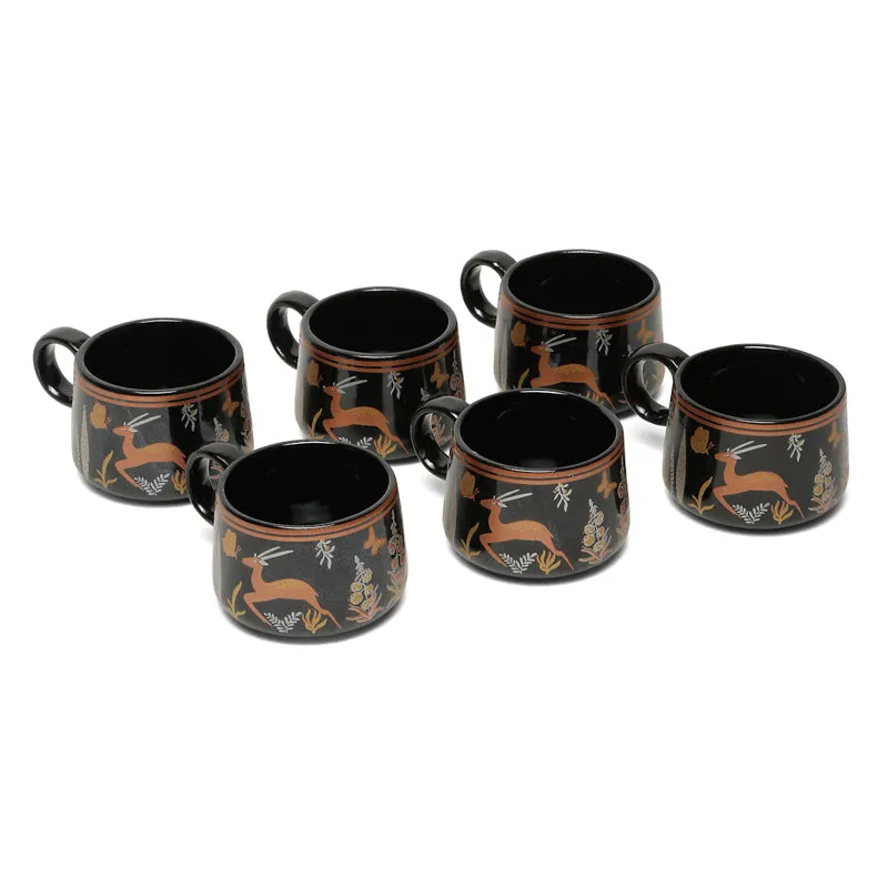 Six black ceramic tea cups with matching wildlife motifs displayed against a white background