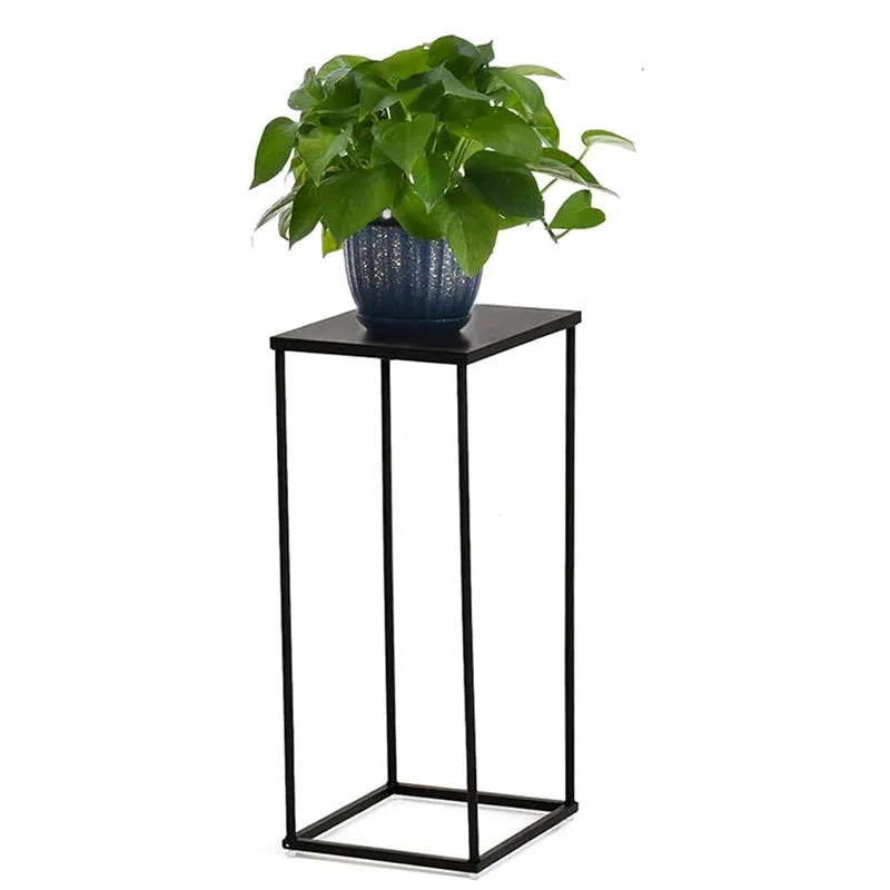 Black square metal planter stand with a leafy plant on a white background.