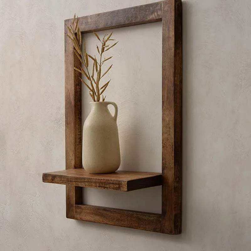 Angled view of a brown wooden wall shelf with a raised frame and display ledge