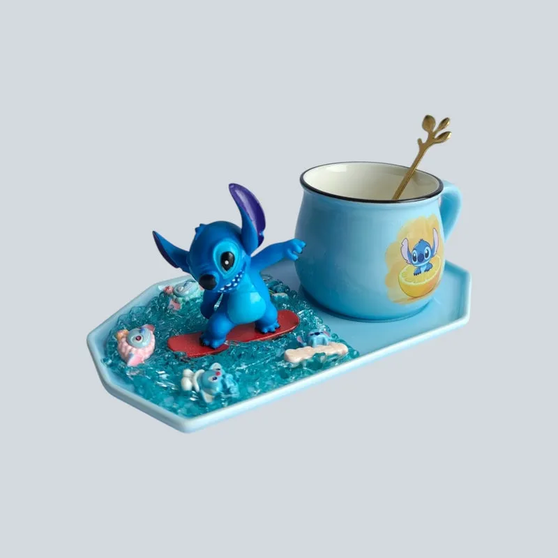 Blue ceramic mug with character figurine and decorative spoon arranged on a matching tray