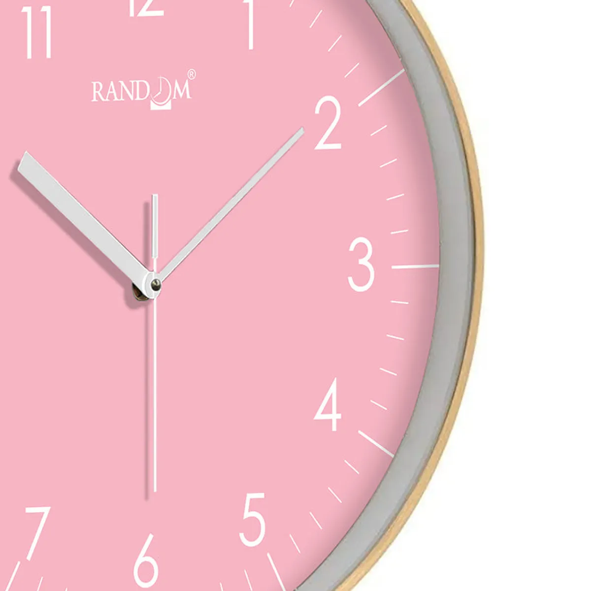 Close-up of the pink clock face with white hands and gold rim
