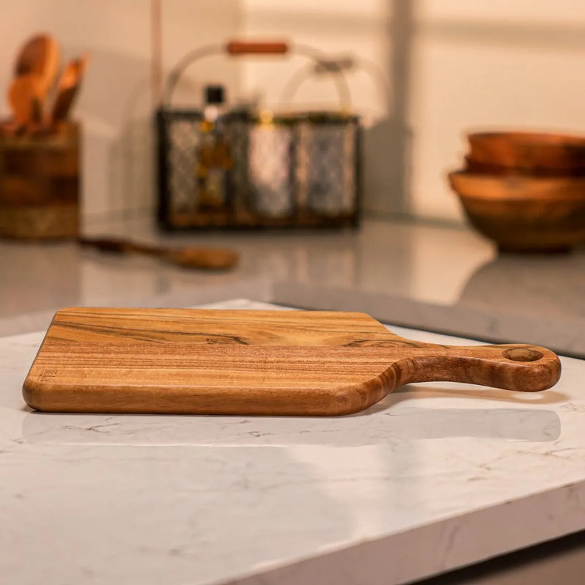 Brown wooden chopping board resting on a kitchen counter