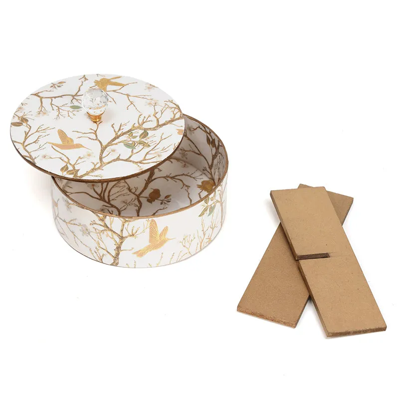 Open white decorative box with its lid beside it and brown backing pieces