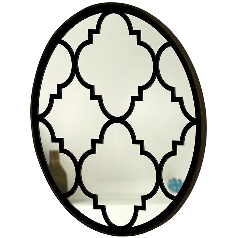 Angled view of round black motif wall mirror