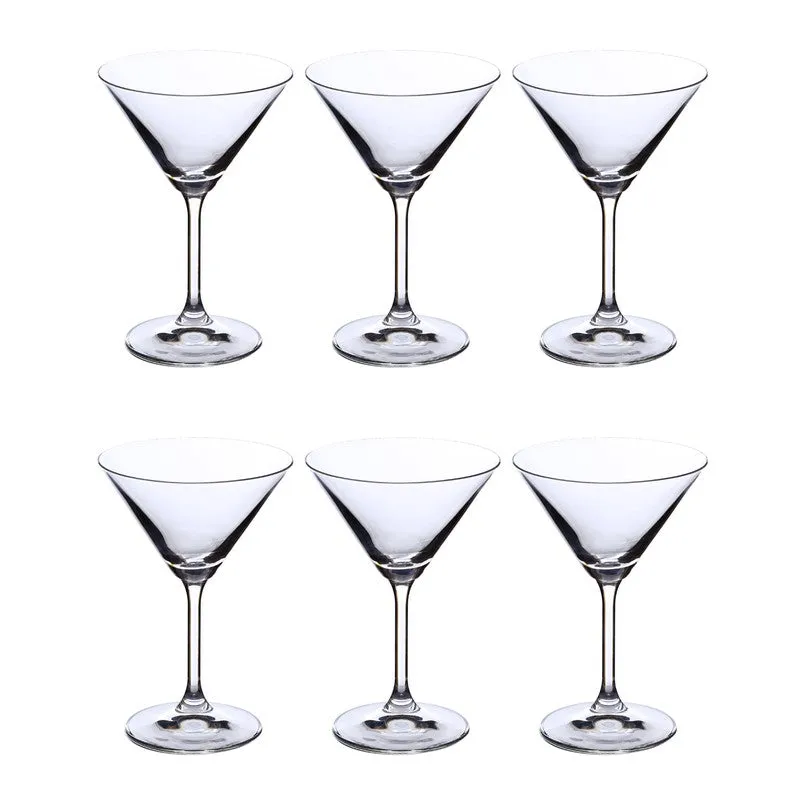 Six clear stemmed cocktail glasses arranged on a white background