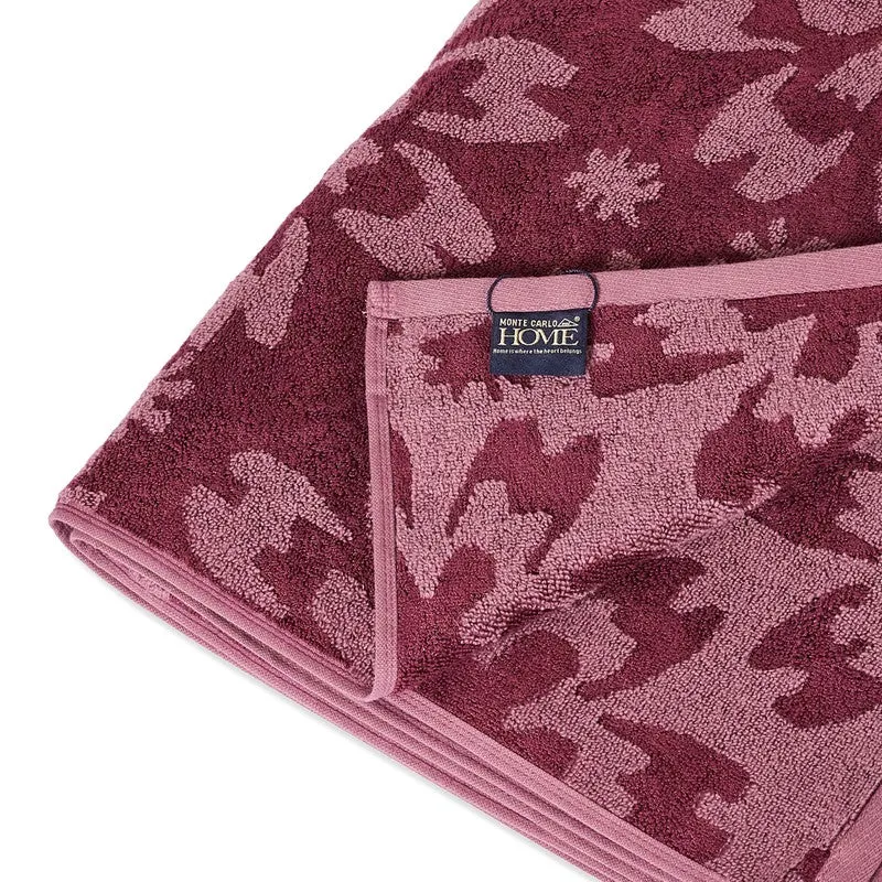 Close-up of the towel edge, border and floral textured surface.