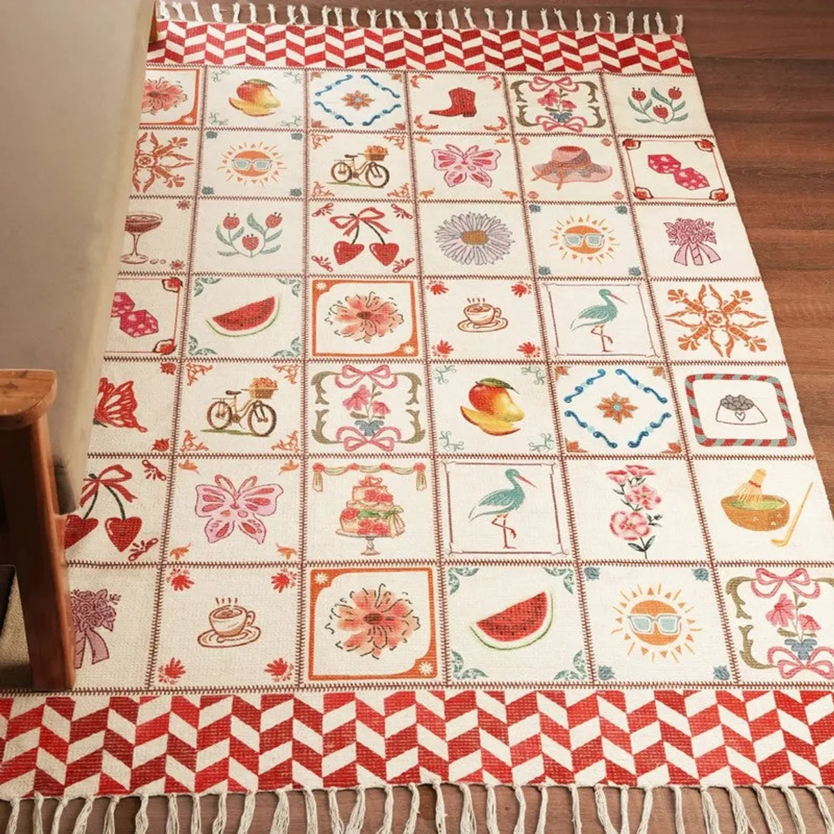 Multicolour rectangular carpet spread on floor with tiled motif pattern and fringed edges