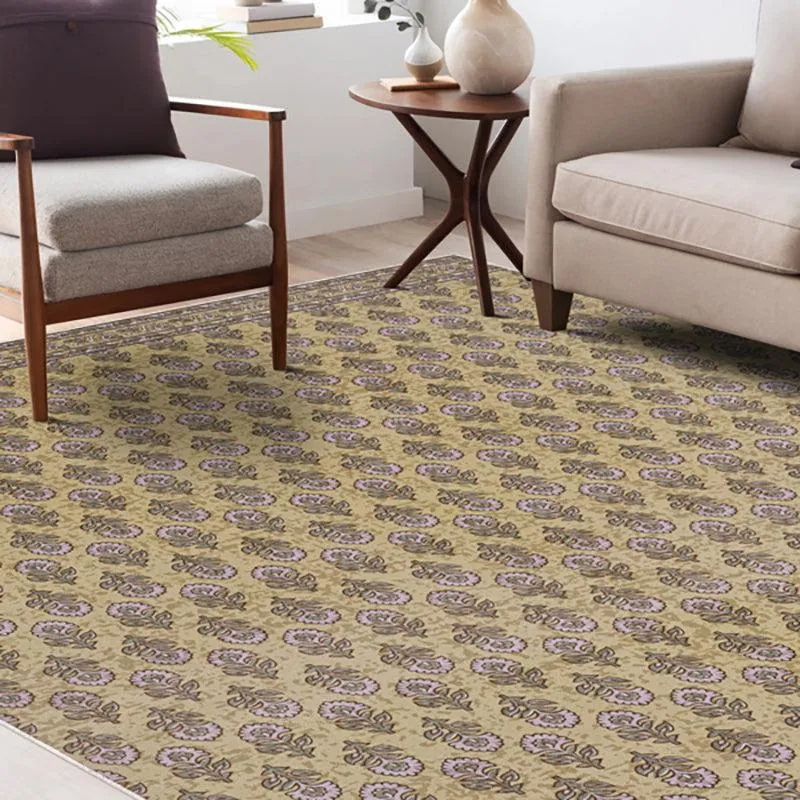 Ethnic patterned beige and green carpet placed in a living room setting