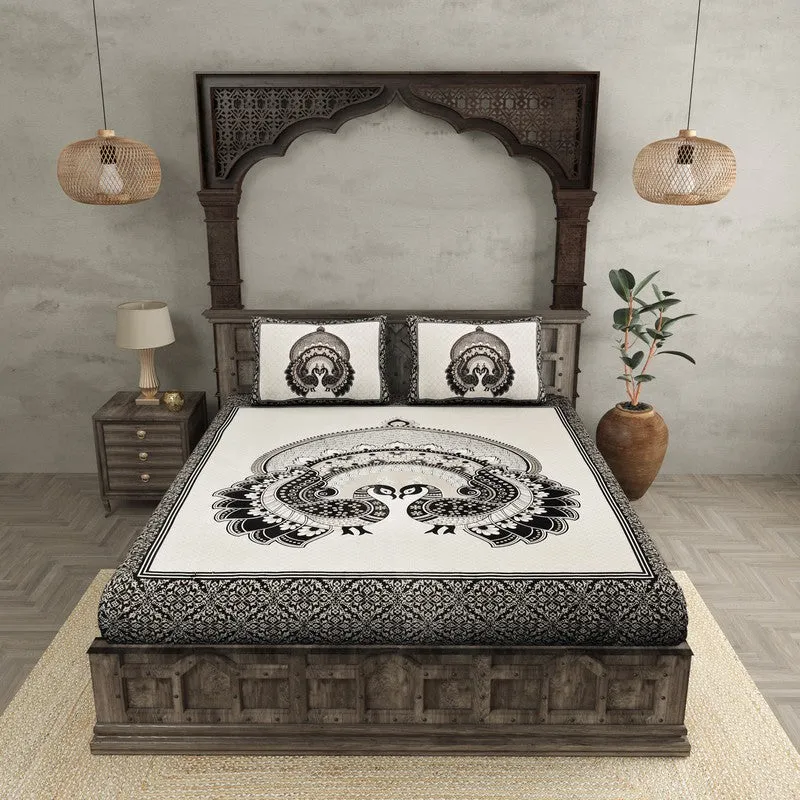 Front view of black and white peacock motif bedsheet on a bed