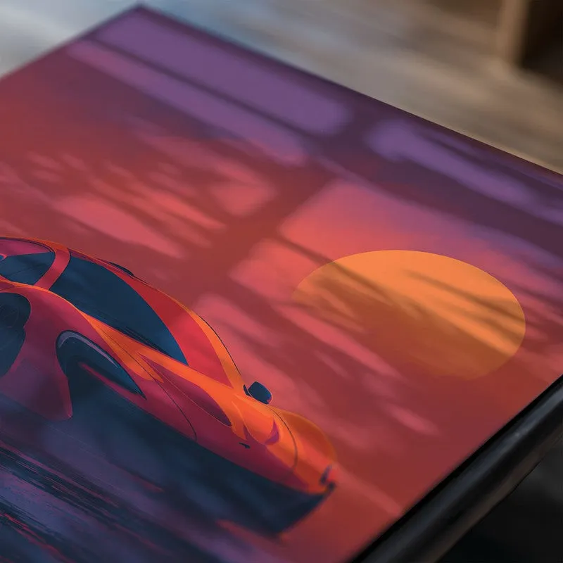 Close-up of car poster with sunset scene in orange and purple tones