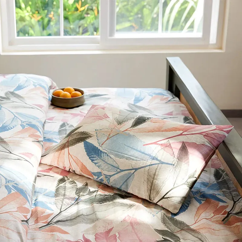 Botanical printed duvet cover styled on a bed beside a window