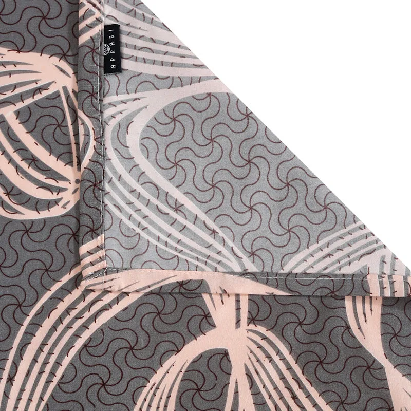 Folded corner detail of grey abstract patterned bedsheet
