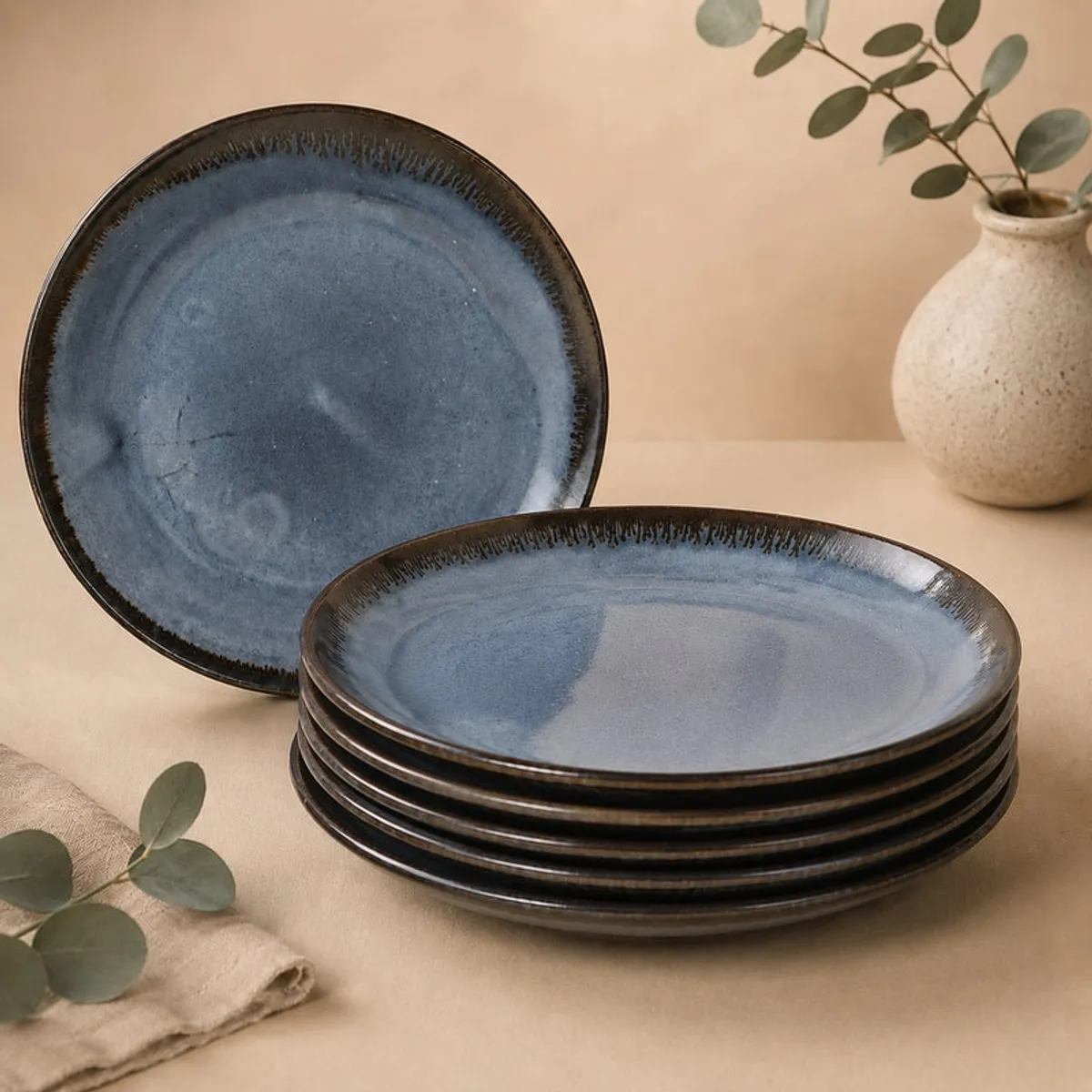 Deep blue ceramic plate shown from above with a dark textured rim