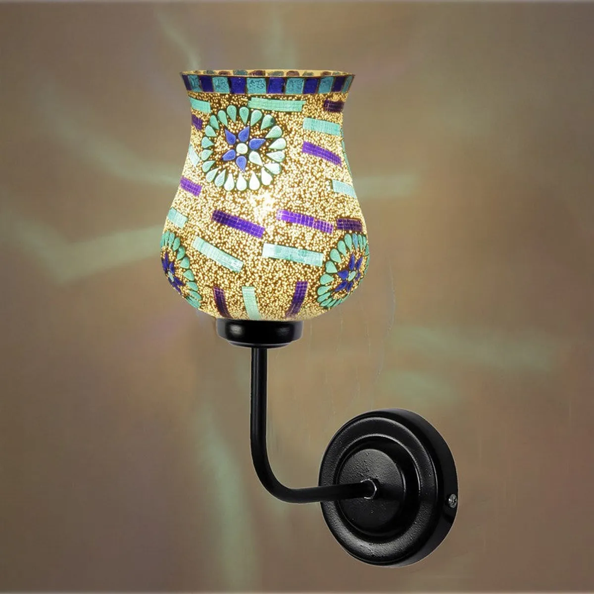 Close view of lit mosaic glass shade on black wall bracket