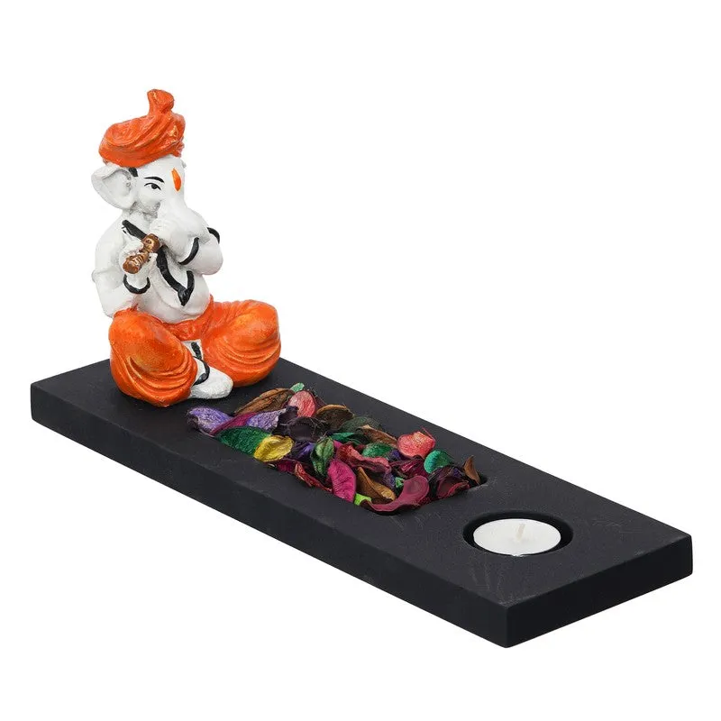 Orange and white Ganesha figurine tea light holder on black rectangular stand