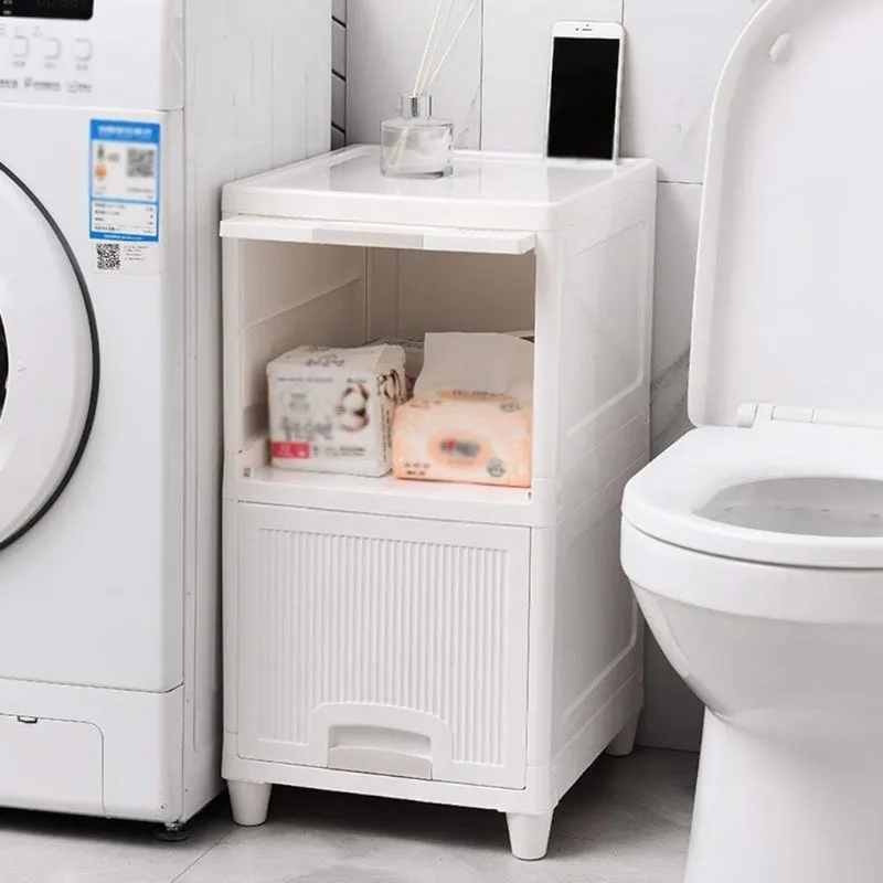 White organizer placed beside a washing machine and toilet