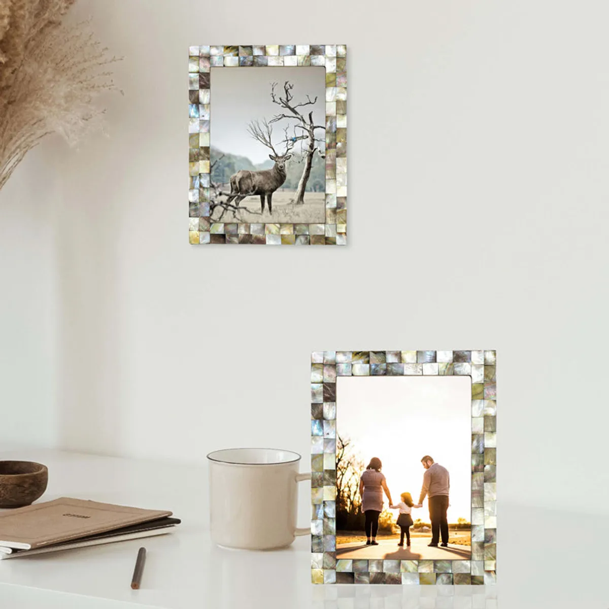 Mother-of-pearl frame displayed on a wall and tabletop with family and wildlife photos.