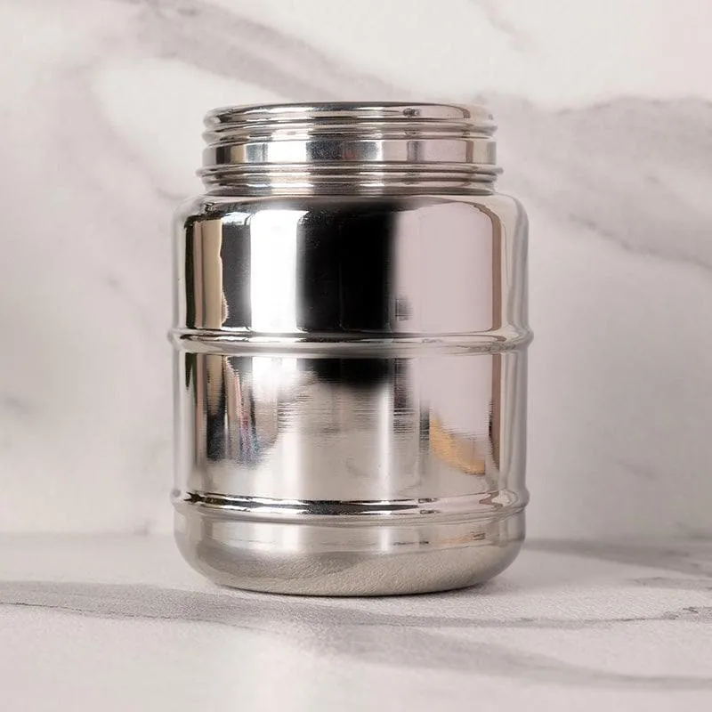 Close-up of a single glossy silver cylindrical storage container