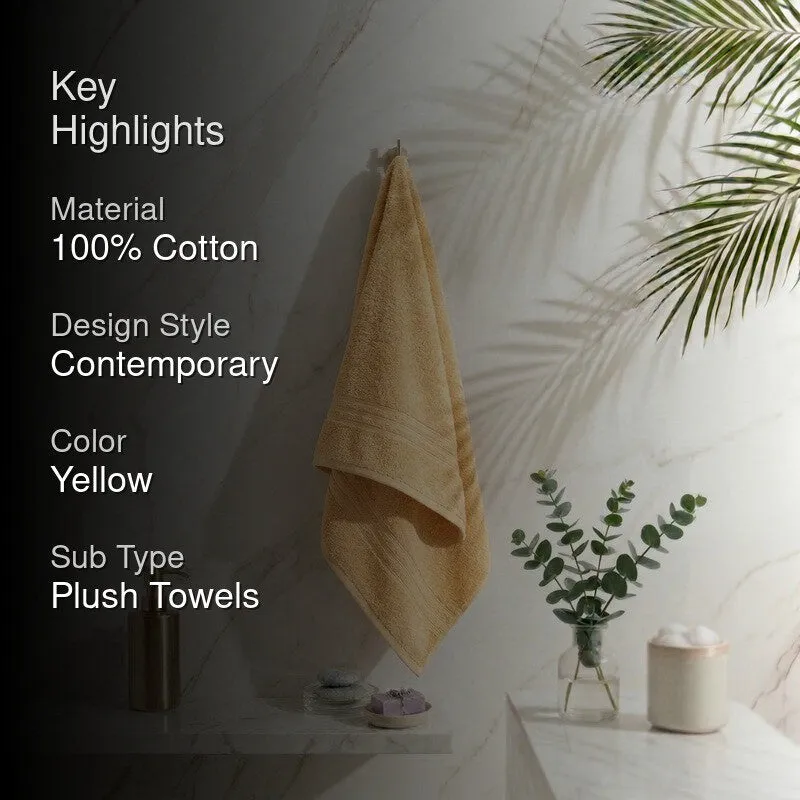 Yellow bath towel hanging in a contemporary bathroom setting