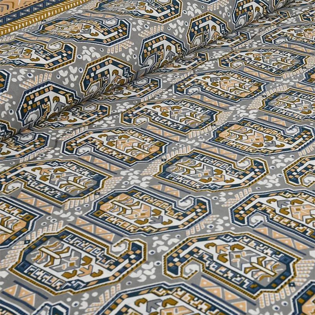 Detailed view of ethnic patterned bedsheet in grey, blue and mustard tones