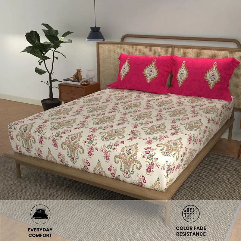 Ethnic print bedsheet with bright pink pillow covers styled on a double bed