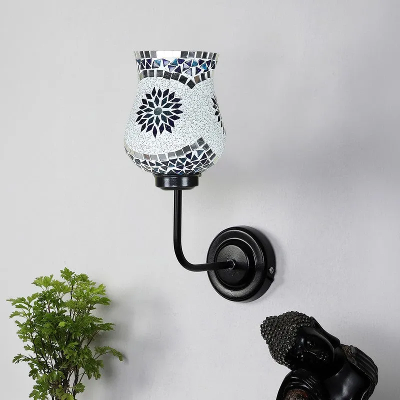 Monochrome floral mosaic wall lamp with black iron base on a white wall