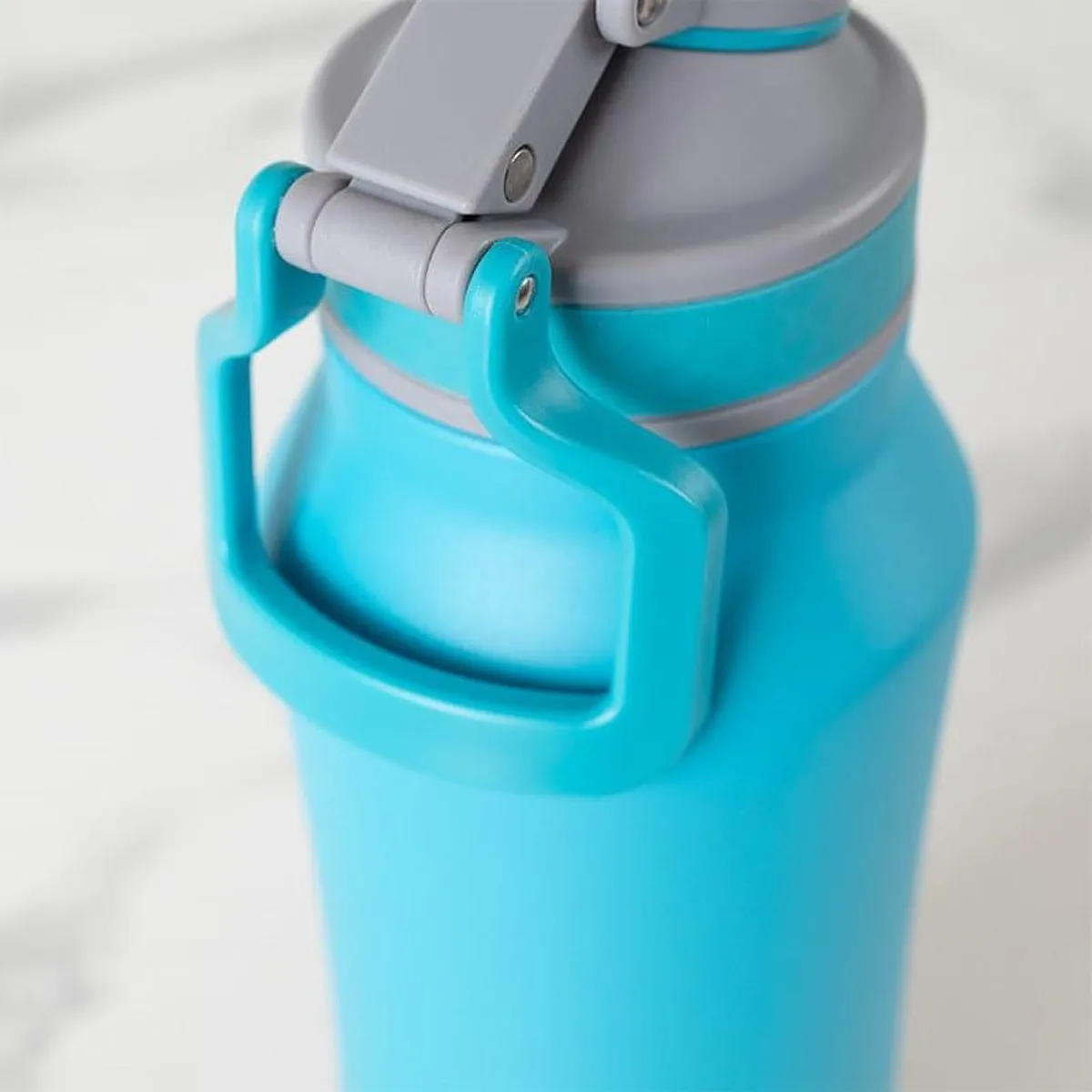 Close-up of the blue bottle's lid and side loop detail