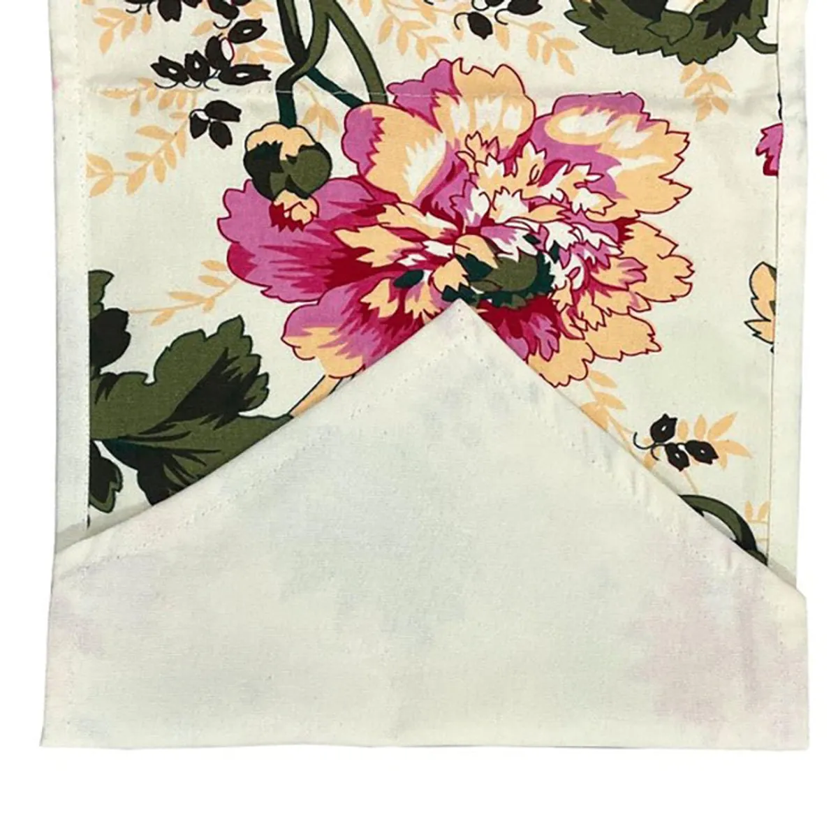 Close-up of the floral print and folded edge of the table runner