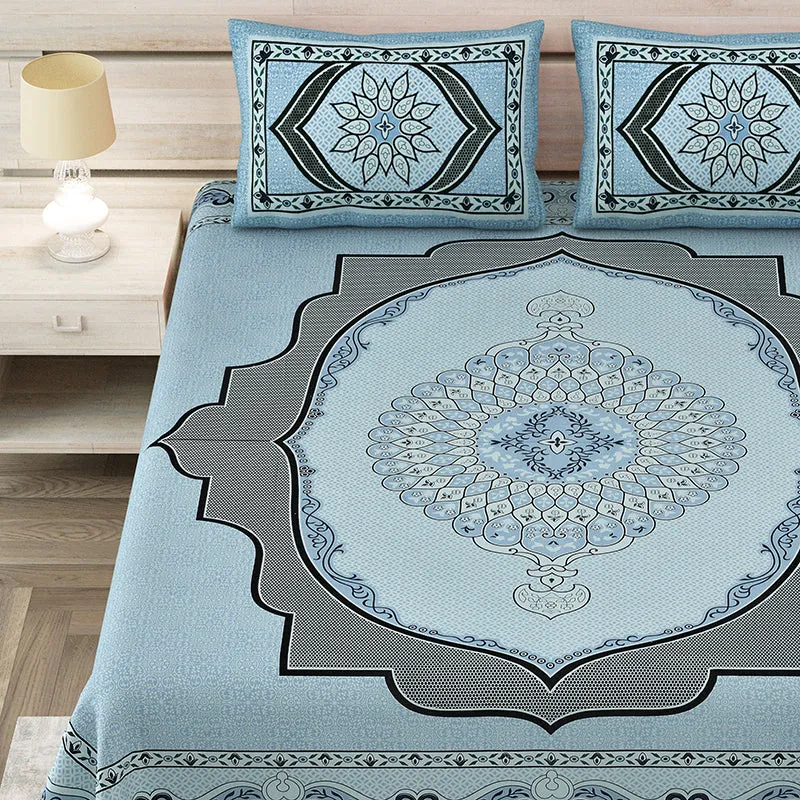 Close view of sky blue bedsheet with detailed central medallion and matching pillow covers