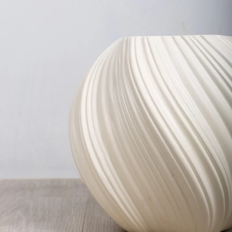 Close-up of the planter's white flowing ribbed texture