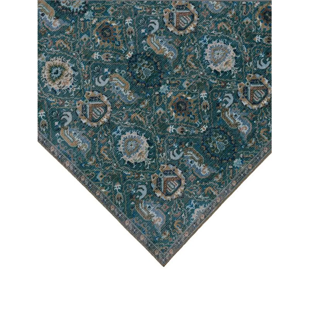 Detailed corner of blue-green ethnic carpet showing repeating beige motifs