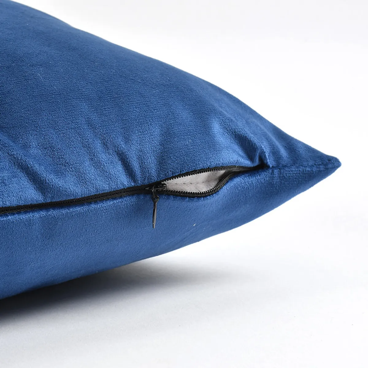 Close-up of blue velvet cushion cover fabric and zip closure