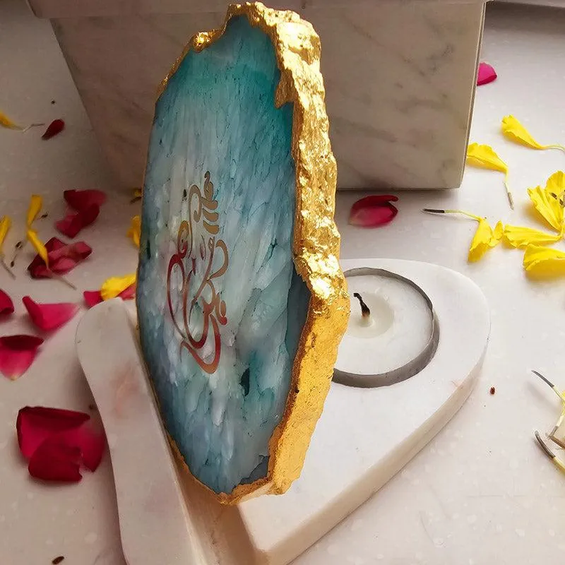 Side view of agate tealight holder showing candle slot on white base