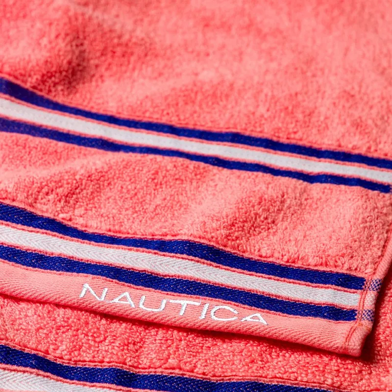 Close-up of orange towel fabric with blue and white stripes