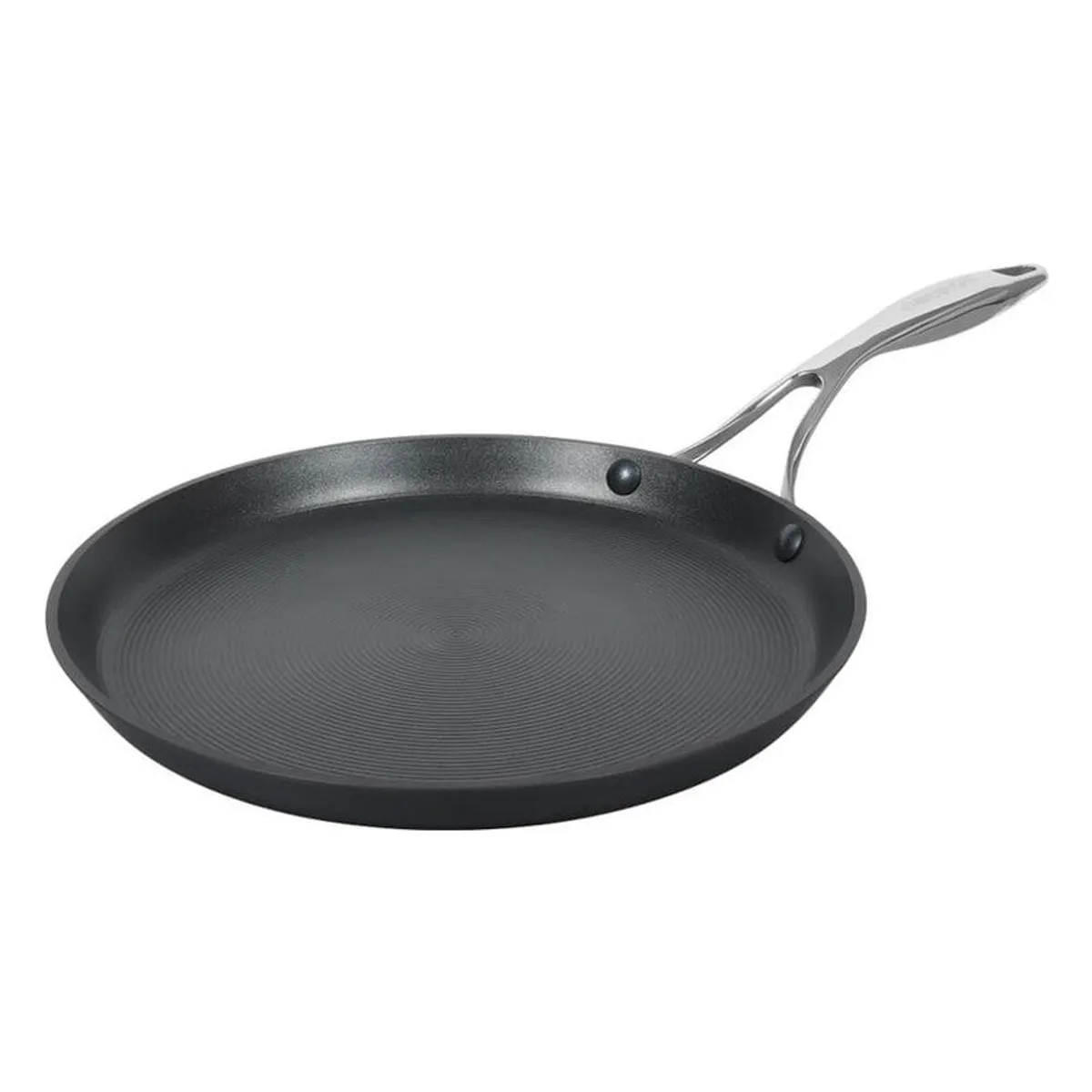 Close view of a black dosa tawa showing its concentric textured cooking surface