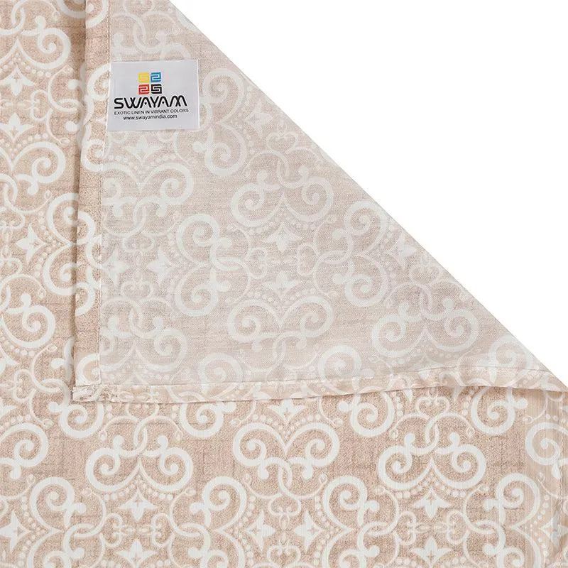 Folded corner of brown and white printed bedding fabric