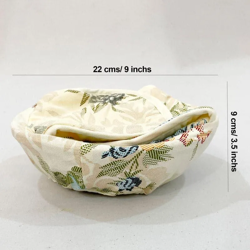 White bread basket with floral cotton cover and rounded padded flaps