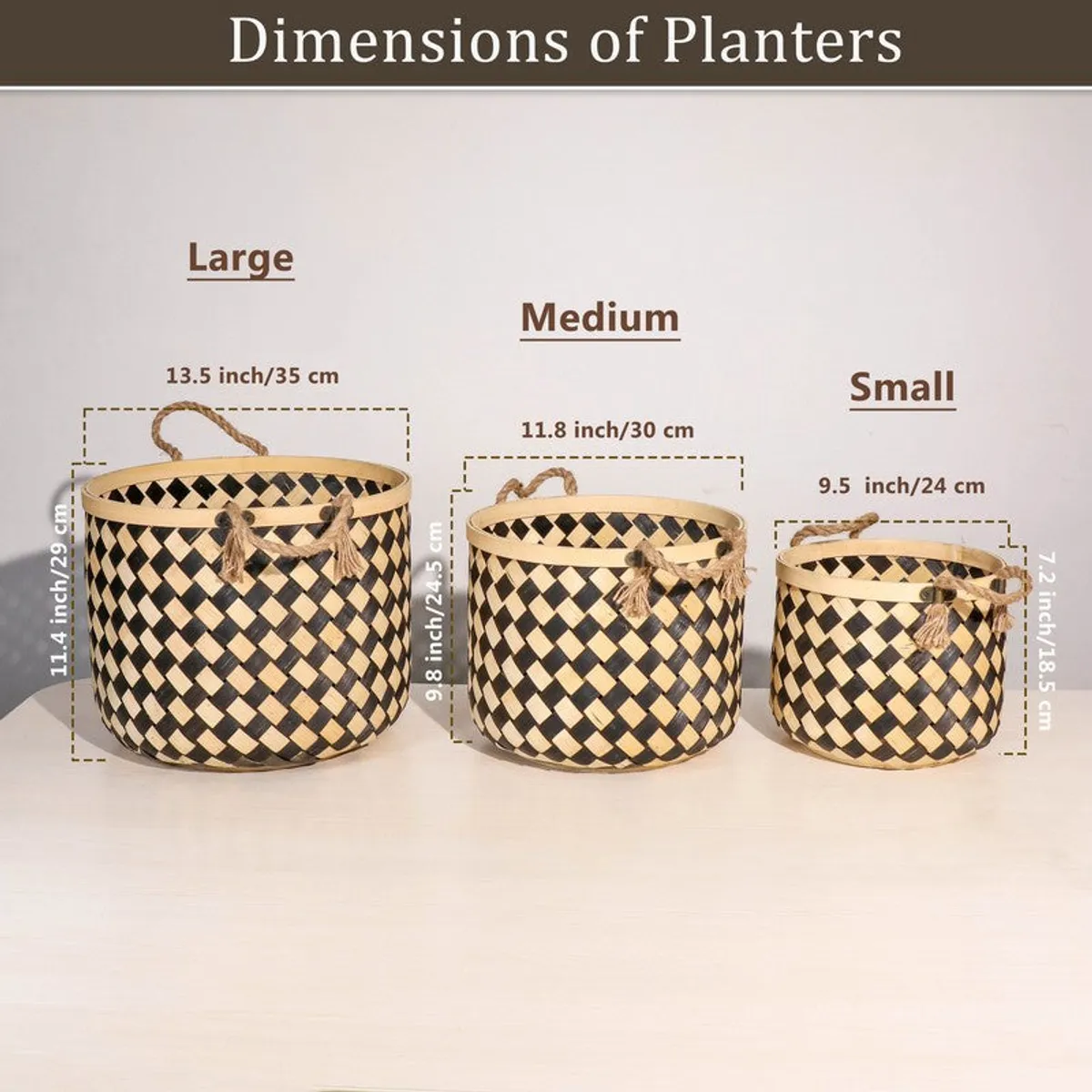 Three black and natural bamboo planters styled beside books and artwork.