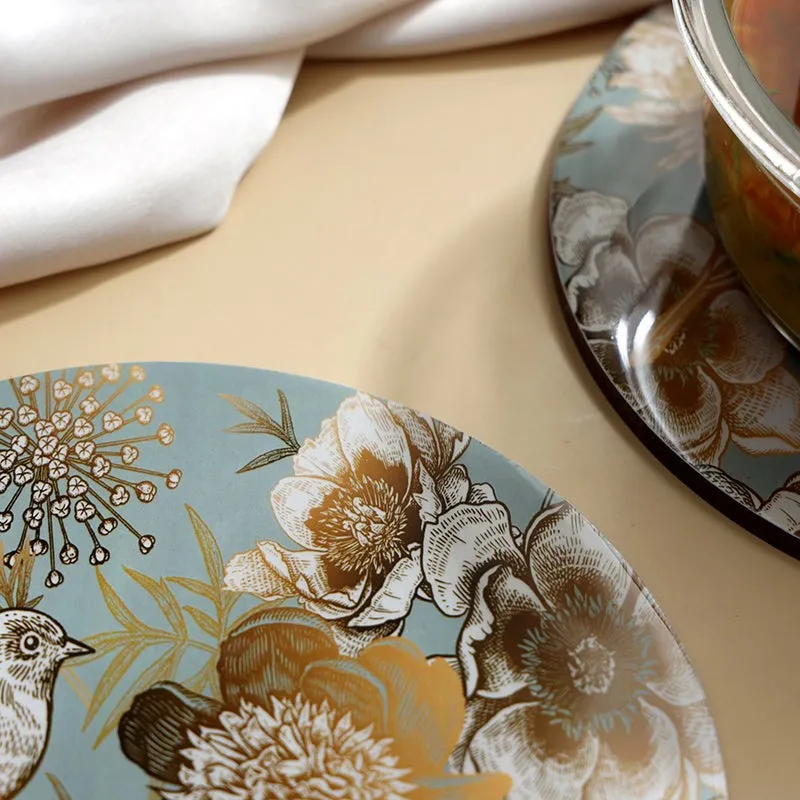 Close-up of floral and bird artwork on a round table mat