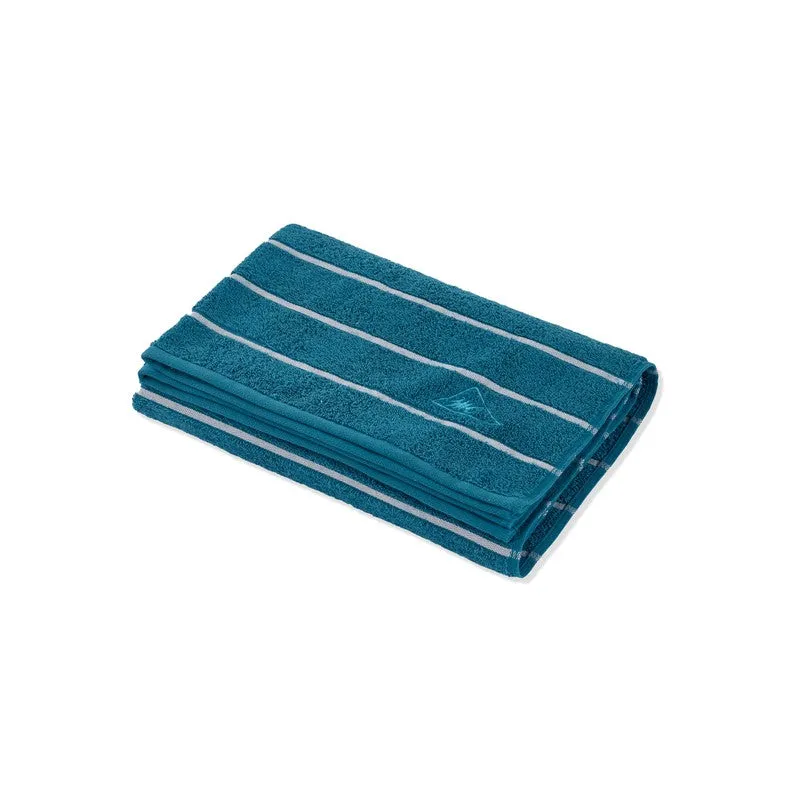 Folded blue striped bath towel on a white background