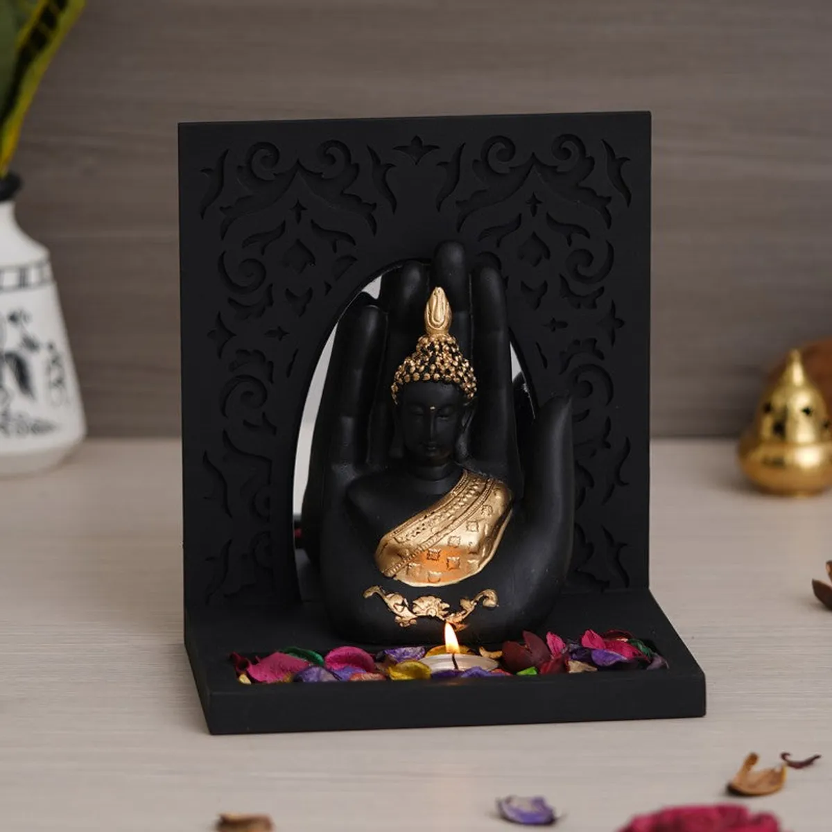 Front view of black and gold Buddha tea light candle holder