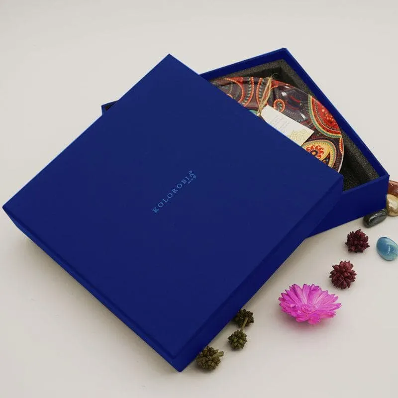 Blue presentation box with a decorative plate partially visible inside