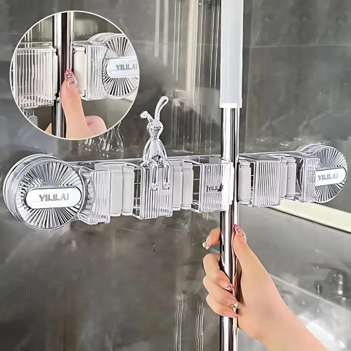 Close-up of transparent wall organiser gripping a mop handle