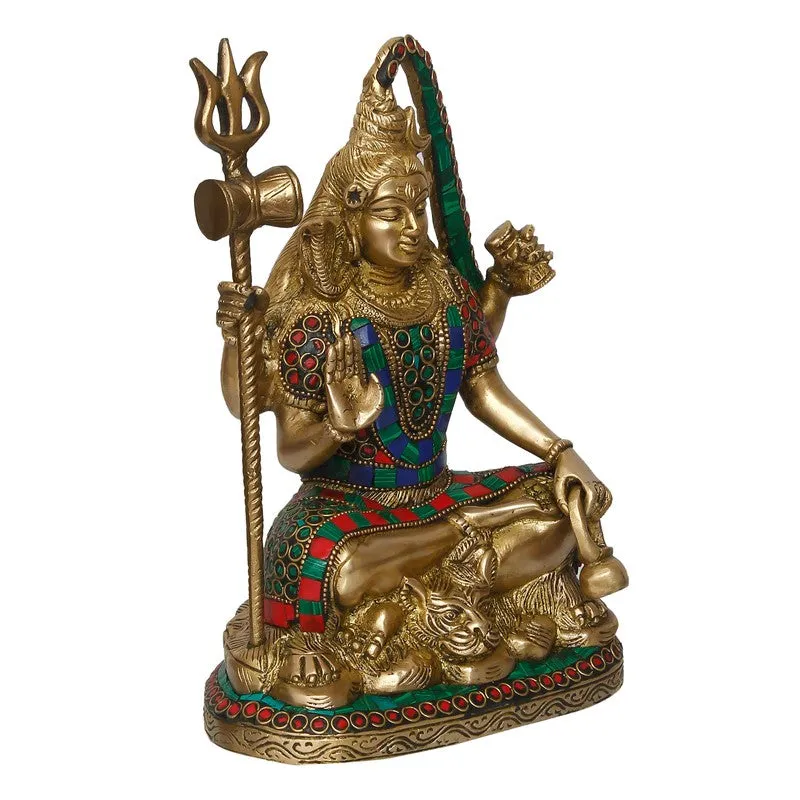 Angled view of a gold-toned deity idol with red and blue embellishment