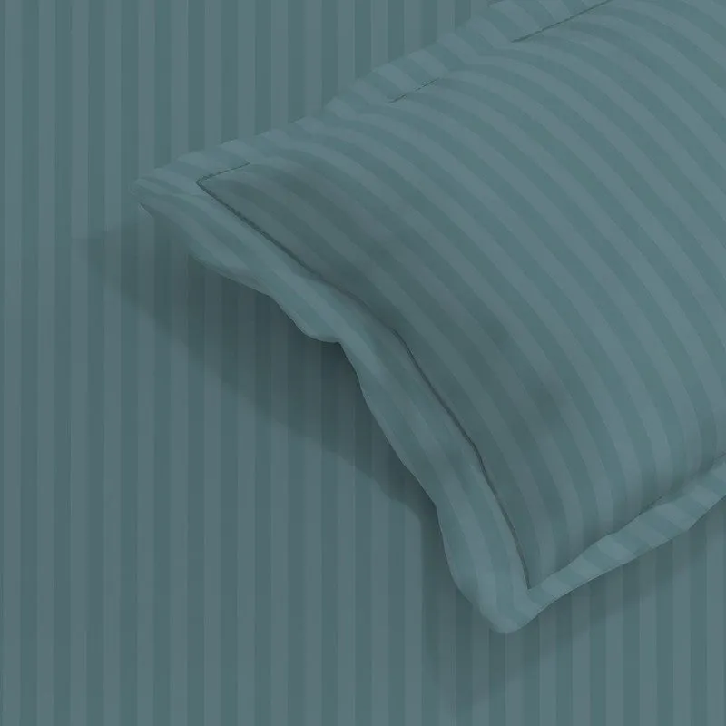 Close-up of teal striped bedding fabric and matching pillow cover