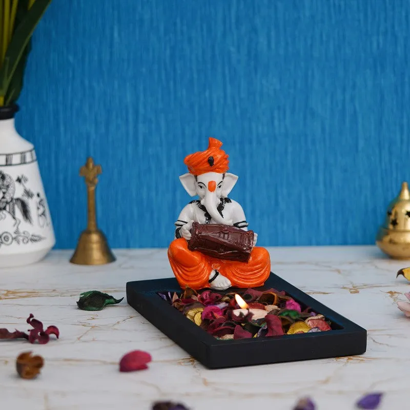 Front angled view of Ganesha tea light holder with glossy orange and white finish