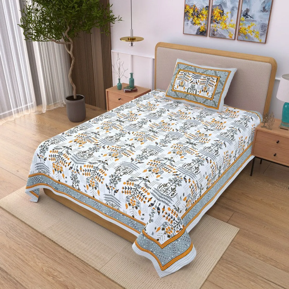 Angled view of blue and yellow floral bedsheet with matching pillow cover on bed