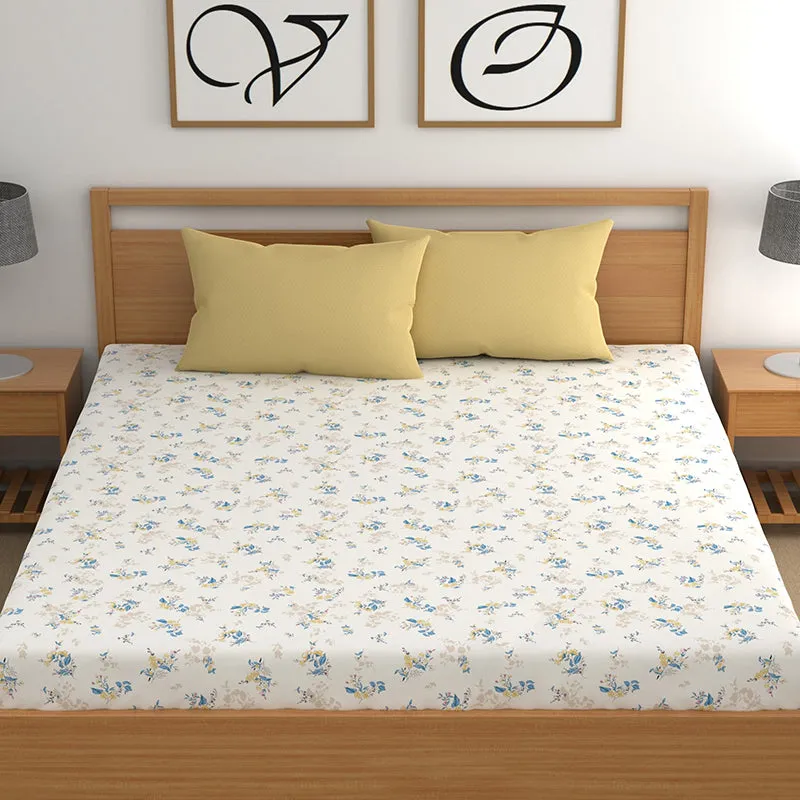 Front view of white floral bedsheet on a wooden bed